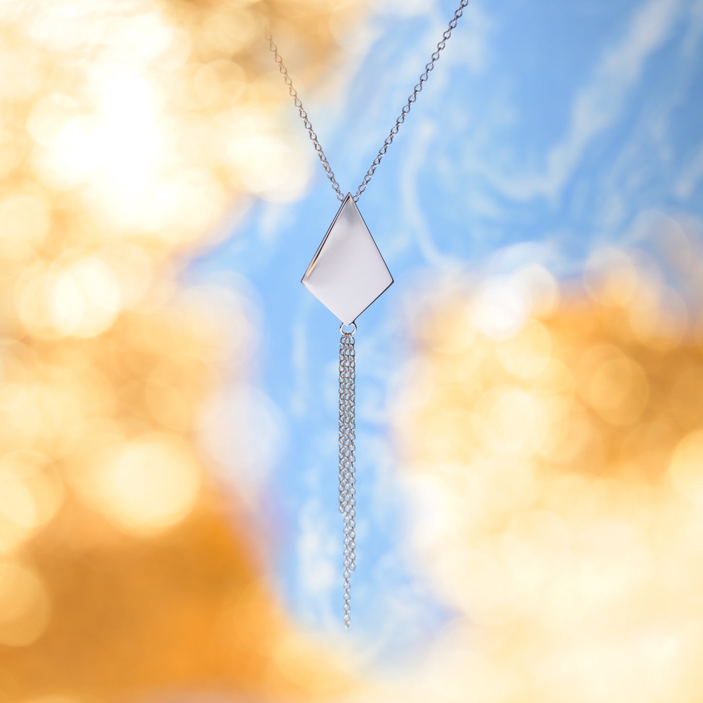 Silver kite shaped necklace with chain tassel