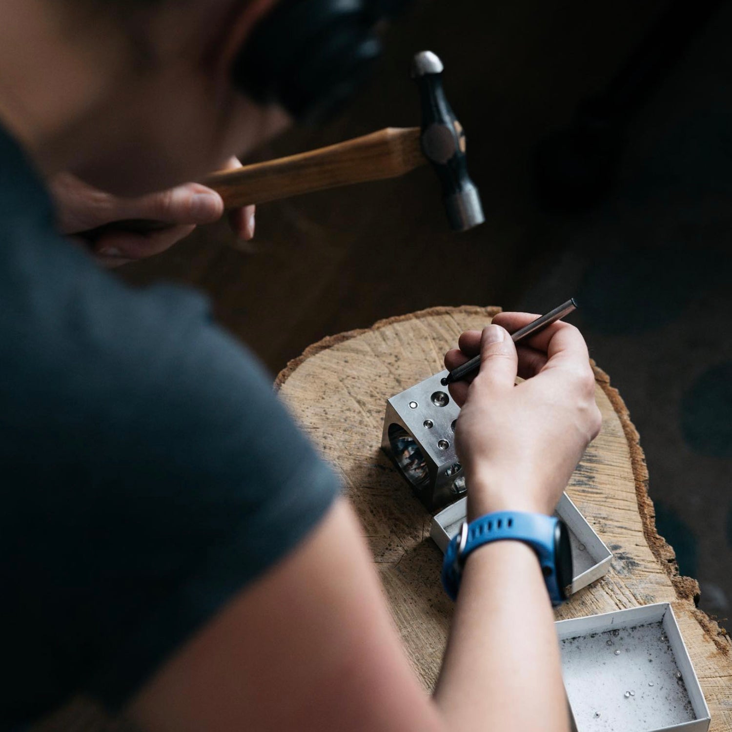 Ali working with a hammer and doming block